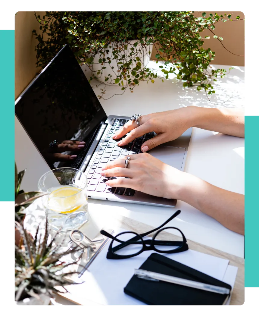 A person typing on their laptop